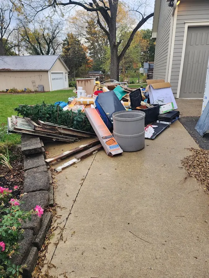 Dumpster being loaded with debris for Estate Cleanout Dumpster Rental in Washington Terrace